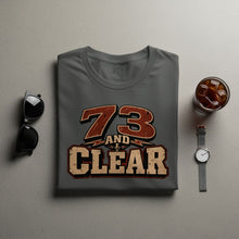 Load image into Gallery viewer, Gray t-shirt with "73 AND CLEAR" text and microphone graphic.
