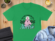 Load image into Gallery viewer, Green t-shirt with "YOU CAN'T SCARE ME I'M A Nurse" text and a ghost graphic.
