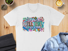 Load image into Gallery viewer, White t-shirt with colorful "She Works Willingly" text and medical icons.
