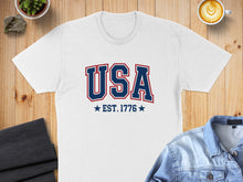 Load image into Gallery viewer, White t-shirt with "USA EST. 1776" printed in blue and red.
