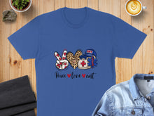 Load image into Gallery viewer, Blue t-shirt with peace sign, heart, and EMT badge graphic.
