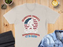 Load image into Gallery viewer, Cream t-shirt with Bigfoot, American flag, and "Celebrating America's Semiquincentennial 1776-2026" text.
