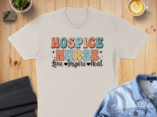 Load image into Gallery viewer, Cream t-shirt with "HOSPICE NURSE Love Inspire Heal" text in colorful retro font.
