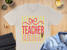 Load image into Gallery viewer, T-shirt with "TEACHER" and "Some days rock it, some days it rocks me, either way we're rockin' it" text.
