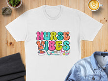 Load image into Gallery viewer, White t-shirt with "Nurse Vibes" in colorful bubbly text and medical icons.
