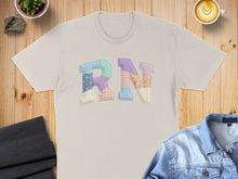 Load image into Gallery viewer, Light tan t-shirt with "RN" in colorful patchwork letters.
