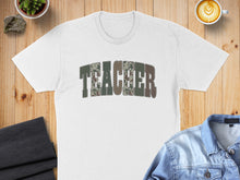 Load image into Gallery viewer, White t-shirt with "TEACHER" text in a camouflage pattern.
