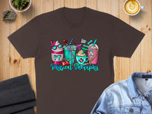 Load image into Gallery viewer, Brown t-shirt graphic with PT Physical Therapy themed drinks and medical elements.
