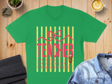 Load image into Gallery viewer, Green t-shirt with pink "TEACHER" text and lightning bolt graphic.
