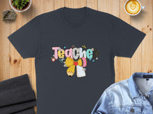 Load image into Gallery viewer, Dark t-shirt with colorful "Teacher" text design featuring pencils and flowers.

