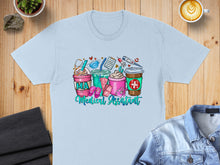 Load image into Gallery viewer, Light blue t-shirt with "Medical Assistant" and coffee cups with medical icons.
