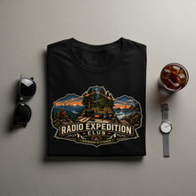 Load image into Gallery viewer, Black t-shirt with "RADIO EXPEDITION CLUB - ANYWHERE IS A SHACK" design.
