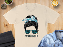 Load image into Gallery viewer, Woman with messy bun wearing bandana and glasses, #NurseLife text.
