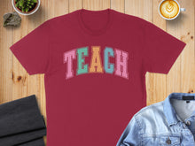 Load image into Gallery viewer, Maroon t-shirt with "TEACH" in colorful block letters.
