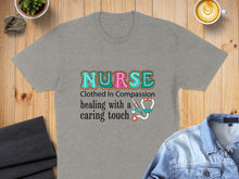 Load image into Gallery viewer, Grey t-shirt with "Nurse Clothed in Compassion Healing with a caring touch" text and stethoscope.
