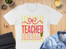 Load image into Gallery viewer, White t-shirt with "TEACHER" and quote about rocking it.
