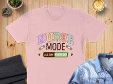 Load image into Gallery viewer, Pink t-shirt with "Nurse Mode All Day Every Day" text and band-aid graphics.
