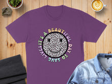 Load image into Gallery viewer, Purple t-shirt with a leopard print smiley face and "It's a beautiful day to save lives" text.
