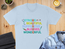 Load image into Gallery viewer, Light blue t-shirt with text "STRONG BEAUTIFUL SUPPORTIVE BLESSED WONDERFUL" and nurse-themed icons.
