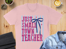 Load image into Gallery viewer, Pink t-shirt with blue stripes and text "JUST SMALL TOWN TEACHER".
