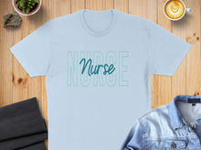 Load image into Gallery viewer, Light blue t-shirt with "Nurse" text in a green outline.
