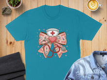 Load image into Gallery viewer, Teal t-shirt with pink XOXO bow featuring stethoscope and heart cross.
