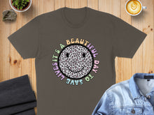 Load image into Gallery viewer, T-shirt with "It's a beautiful day to save lives" text and leopard print smiley face.
