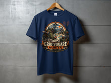 Load image into Gallery viewer, Navy t-shirt graphic with "Grid Square Hunter" text, compass, and outdoor scene.
