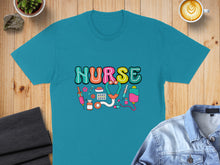 Load image into Gallery viewer, Turquoise t-shirt with "NURSE" in colorful lettering and medical graphics.
