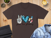 Load image into Gallery viewer, Brown t-shirt with "peace love pharmacy" text and pharmacy-themed graphics.
