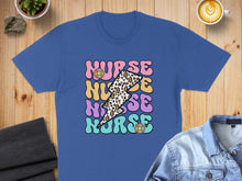 Load image into Gallery viewer, Blue t-shirt with "Nurse" in colorful, retro text and lightning bolt pattern.
