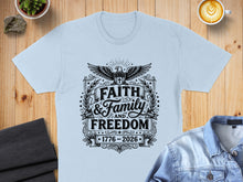 Load image into Gallery viewer, Light blue t-shirt with "Faith &amp; Family &amp; Freedom" and "1776-2026" design.
