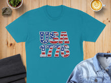 Load image into Gallery viewer, Teal t-shirt with "USA 1776" in a patriotic, distressed font.
