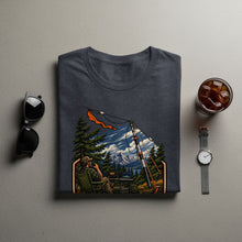 Load image into Gallery viewer, T-shirt graphic depicts a man with a radio in the mountains.
