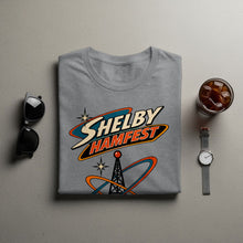 Load image into Gallery viewer, Grey t-shirt with "SHELBY HAMFEST" text and radio tower graphic.
