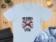 Load image into Gallery viewer, Light blue t-shirt with "NO KINGS IN AMERICA SINCE 1776" text and a crossed flag graphic.

