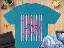 Load image into Gallery viewer, Teal t-shirt with "I'M THE COOL TEACHER THEY TOLD YOU ABOUT" text and a pink bow.
