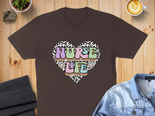 Load image into Gallery viewer, Brown t-shirt with "Nurse Life" text inside a colorful, patterned heart.
