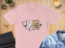 Load image into Gallery viewer, Pink t-shirt with "RN" design featuring a stethoscope, eyeballs, and spiders.
