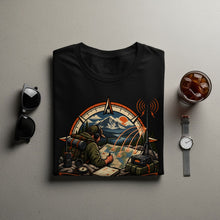 Load image into Gallery viewer, Black t-shirt with a graphic of a hiker with map, compass, and radio in mountains.
