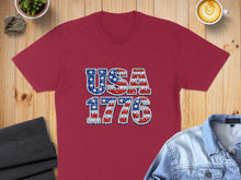 Load image into Gallery viewer, Maroon t-shirt with "USA 1776" in patriotic mosaic design.
