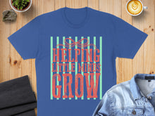 Load image into Gallery viewer, Blue t-shirt with "Helping Little Minds Grow" text and striped design.
