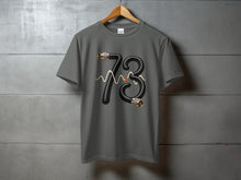 Load image into Gallery viewer, Gray t-shirt with "73" made of black cable and a wavy line.

