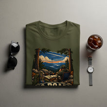 Load image into Gallery viewer, Olive green t-shirt with graphic of man with radio in mountain landscape.
