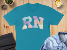 Load image into Gallery viewer, Teal t-shirt with "RN" sewn in colorful patchwork letters.
