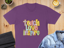 Load image into Gallery viewer, Purple t-shirt with "Teach Love Inspire" text in colorful retro lettering.
