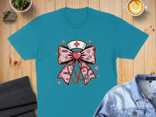 Load image into Gallery viewer, Teal t-shirt with pink stethoscope, bow, and medical cross graphic.
