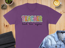 Load image into Gallery viewer, Purple t-shirt with "TEACHER" in colorful polka dots and "teach love inspire" below.
