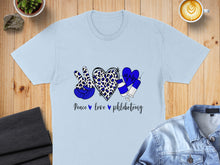 Load image into Gallery viewer, Light blue t-shirt with "Peace love phlebotomy" design featuring leopard print, hearts, and syringes.
