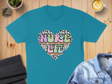 Load image into Gallery viewer, Teal t-shirt with a leopard print heart graphic saying "Nurse Life".
